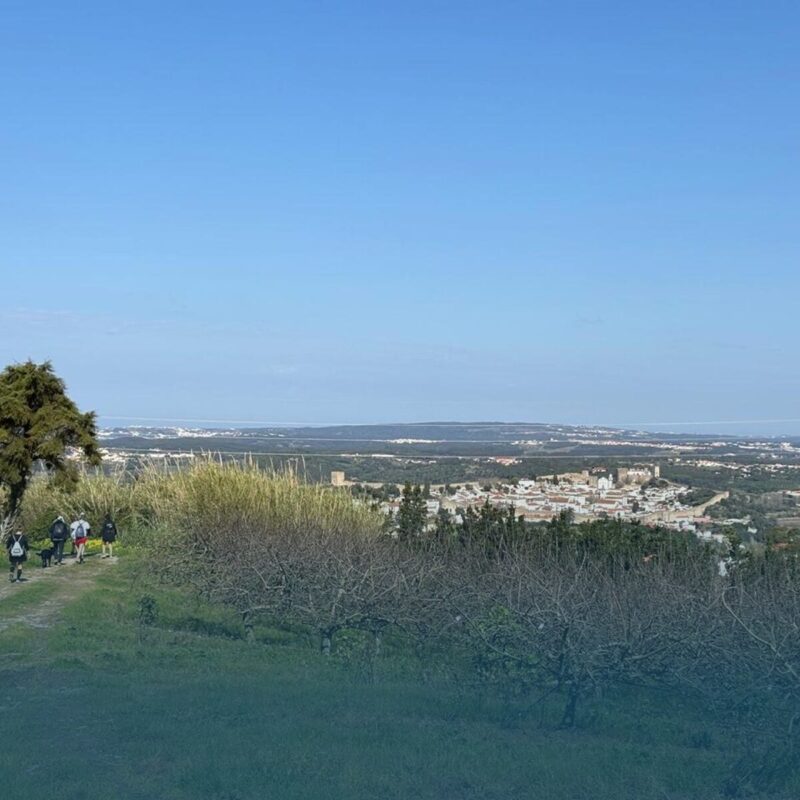 Group hiking the Óbidos Nature Trail with panoramic views over the village and countryside