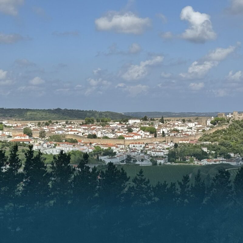 Hikers enjoying the panoramic view over Óbidos from the Vista Trail.