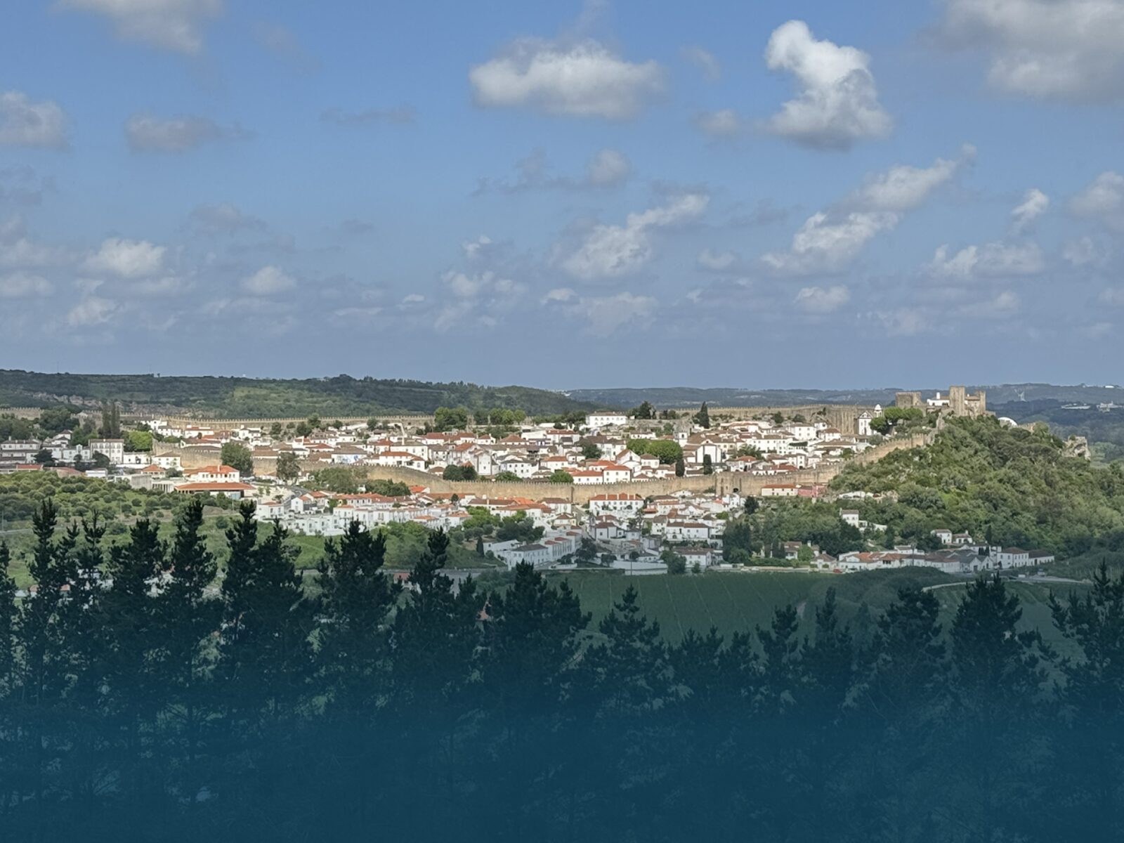 Hikers enjoying the panoramic view over Óbidos from the Vista Trail.